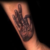 3D style colored human hand tattoo on forearm stylized with Hinduism symbol