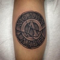 3D style colored leg tattoo of ancient coin with lettering