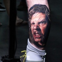 3D style colored very detailed angry man portrait tattoo on leg with funny mustache