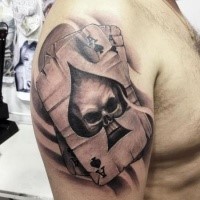 3D style detailed shoulder tattoo of playing cards stylized with skull