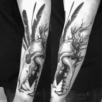 3D style large forearm tattoo of animal skull with black feather