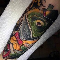 3D style multicolored human like chameleon tattoo on forearm with book and cup