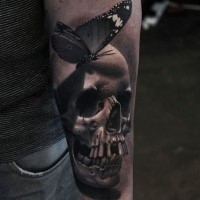 3D style neo traditional style colored forearm of human skull with butterfly