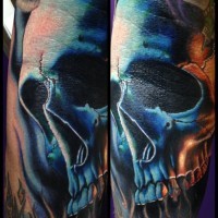 3D style painted colored mystical skull tattoo on forearm stylized with flames