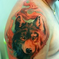 3D style painted natural looking colored wolf head tattoo on shoulder combined with mystical fog