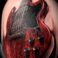 3D style realism looking shoulder tattoo of detailed guitar