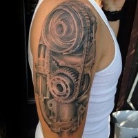 3D style realistic looking colored shoulder tattoo of engine parts