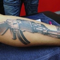 3D style very detailed AK rifle tattoo on arm