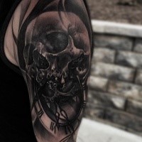 3D style very detailed shoulder tattoo of human skull with clock