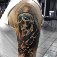 3D style very detailed shoulder tattoo of human skull with helmet and bike rider