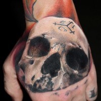 3D very detailed colored hand tattoo of realistic skull