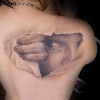 3D very realistic looking ripped paper like under skin face tattoo on shoulder