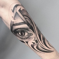 Tatuaje abstracto negro y gris en el antebrazo