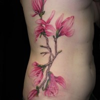 eccezionale fiore brillante di magnolia colore rosa con scrittura tatuaggio su lato