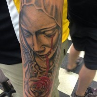 Amazing religious bleeding-eye Virgin Mary tattoo on forearm