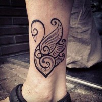 Amazing tribal black-ink swan tattoo on ankle