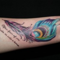 Amazing vivid-colored peacock feather with quote tattoo on arm