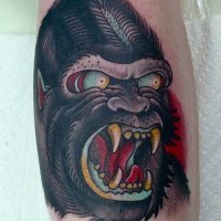 Angry old school color-ink gnarling gorilla head tattoo on arm