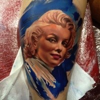 Art style colored leg tattoo of Merlin Monroe portrait