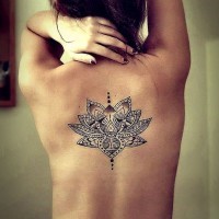 Awesome black-and-white tribal lotus flower tattoo on back