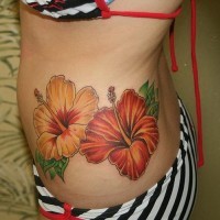 Awesome orange hawaiian flowers tattoo on side