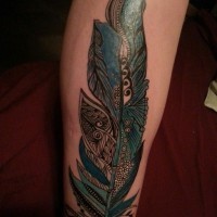 Awesome turquoise tribal feather tattoo on arm