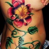 Beautiful colorful exotic flower tattoo on side