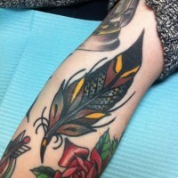 Beautiful colorful old school feather tattoo on arm