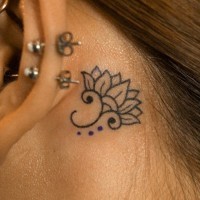 Beautiful elegant small black-ink lotus flower tattoo behind ear