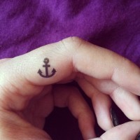 Beautiful tiny anchor tattoo on finger side