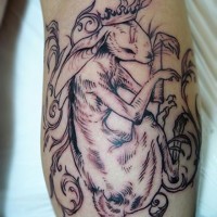 Beautiful uncolored hare in crown tattoo on arm