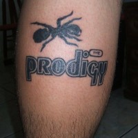 Big black-ink ant with prodigy quote tattoo on shin