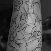 Black-contour flower tattoo sleeve on forearm