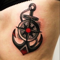 Black anchor with centered wheel tattoo on rib-side