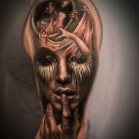 Black and gray style detailed upper arm tattoo of creepy woman with portrait
