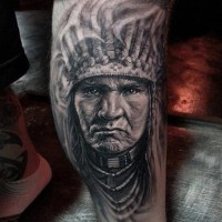 Black and white Indian head tattoo on shin