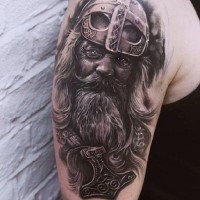 Black and white Viking warrior head tattoo on shoulder