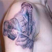 Black and white Viking with axe tattoo on shoulder