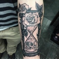 Black grey life and death hourglass forearm tattoo