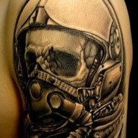 Black ink detailed modern pilon skull tattoo on upper arm