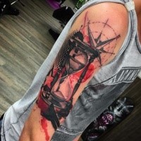 Black red trash polka hourglass tattooo on shoulder