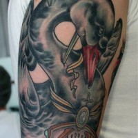 Black swan pierced by knifes tattoo on upper arm