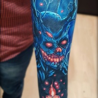 Blue demon tattoo on forearm