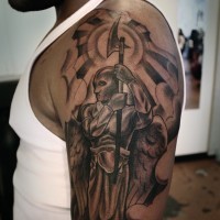 Calm angel warrior with axe tattoo on shoulder
