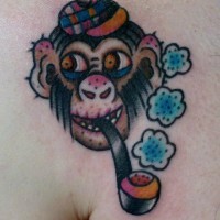 Cartoon colorful chimpanzee with tobacco pipe tattoo on chest