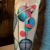 Cartoon style colored arm tattoo of planets by Mariusz Trubisz