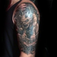 Cartoon style colored upper arm tattoo of evil statue