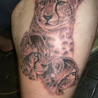 Cheetah mother with cubs tattoo on thigh