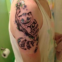 Disappearing cheshire cat tattoo on shoulder