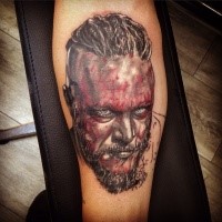 Colored portrait of viking tattoo on leg